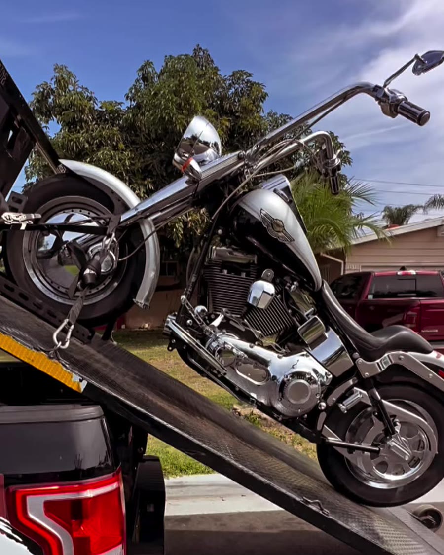 Silver cruiser loading on Law Tigers branded black truck lift