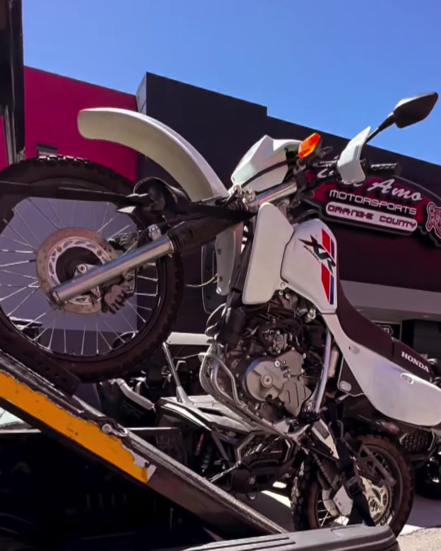 Honda XR dual-sport on Law Tigers black truck at Del Amo